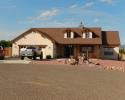 This gorgeous home features tan stucco accompanied with redwood trim for a rustic feel. 